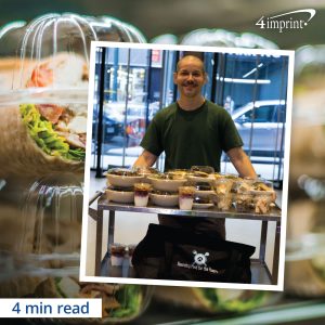 volunteer with Rescuing Leftover Cuisine standing next to a table filled with donated fresh food - 4 minute read time