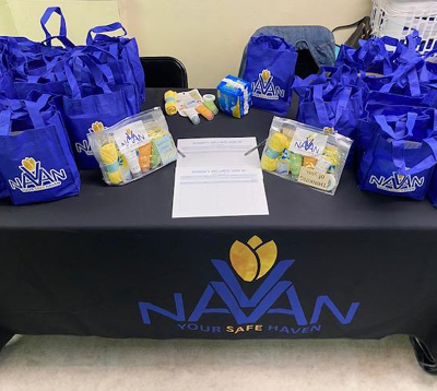 table of swag bags for community event filled with women's wellness essentials