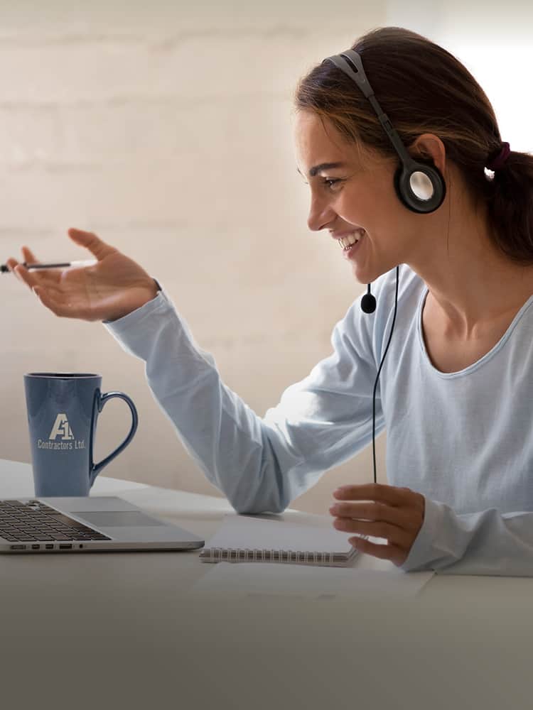 Woman with headphones looking at computer