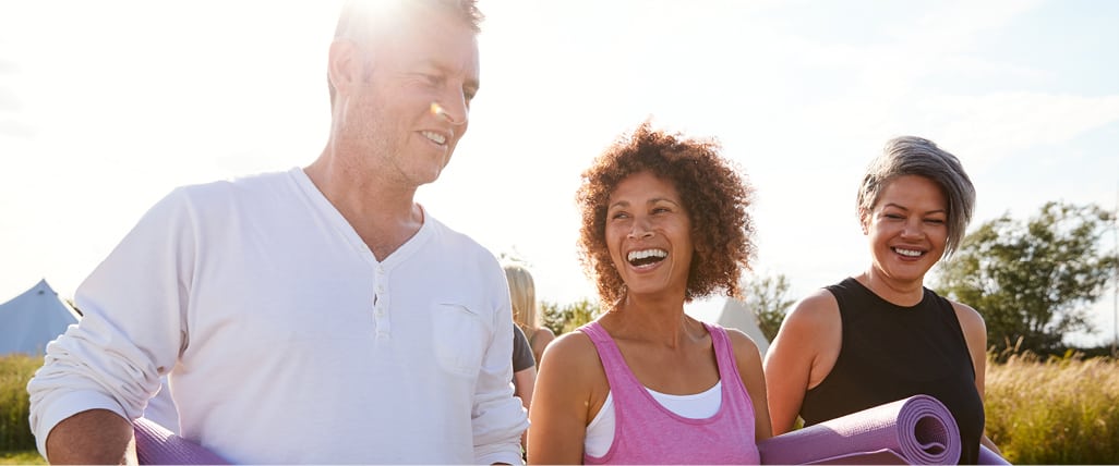 group of three adults walking outside in exercise clothes