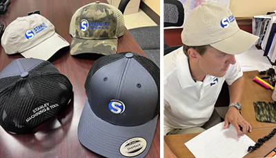 company displaying 4 different branded baseball hats for their employees to choose from