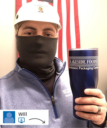 Man wearing facemask and hard hat holding branded company travel tumbler