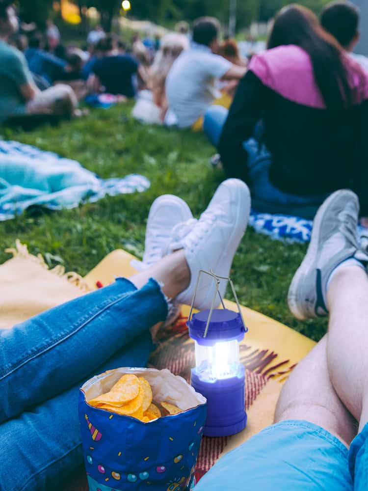 People sitting on blanket at outdoor event