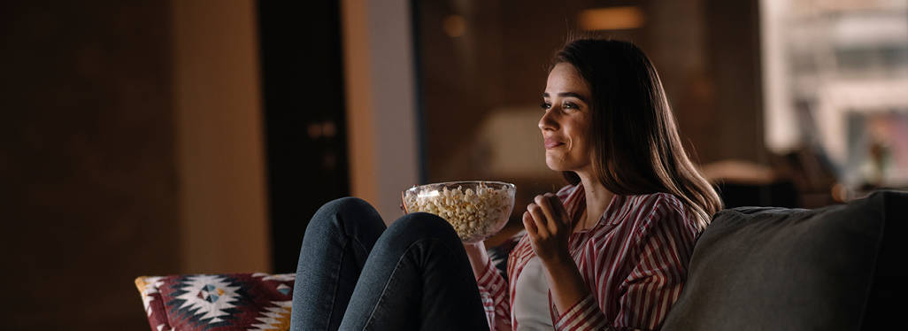 Woman eating a bowl of popcorn