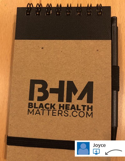 A black and brown notebook with a logo on its cover.