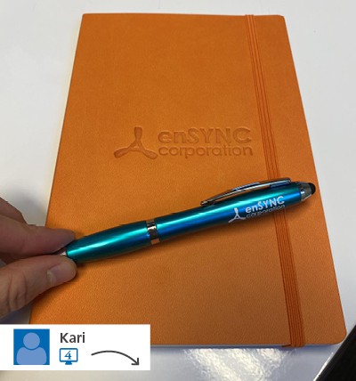 An orange notebook with a logo on its cover.