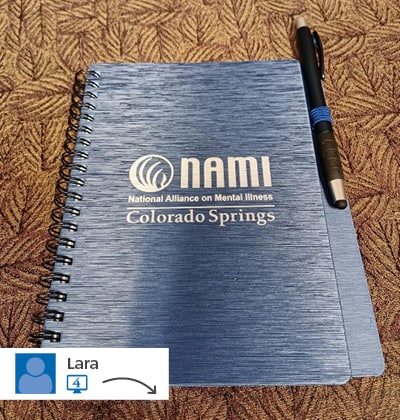 A blue notebook with a logo on its cover.