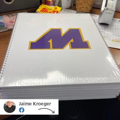 A white notebook with a logo on its cover.