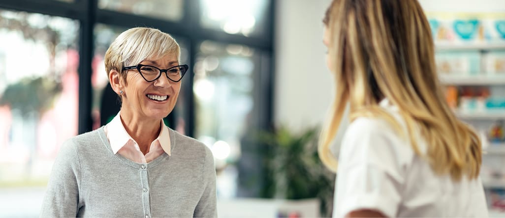 Two women smiling at each other.