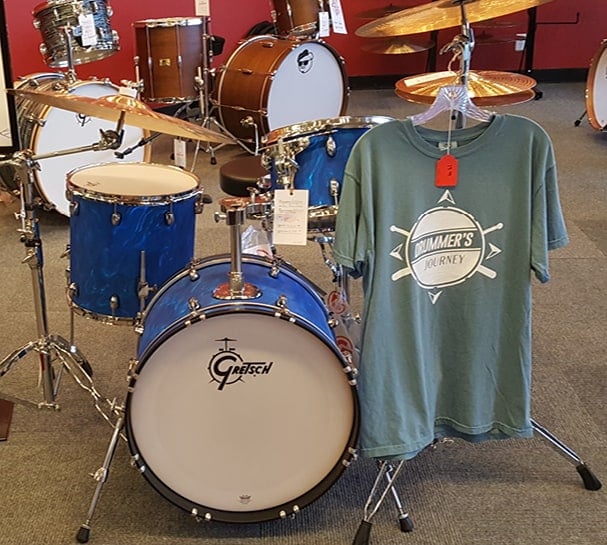 drumset with branded shirt hanging from symbol