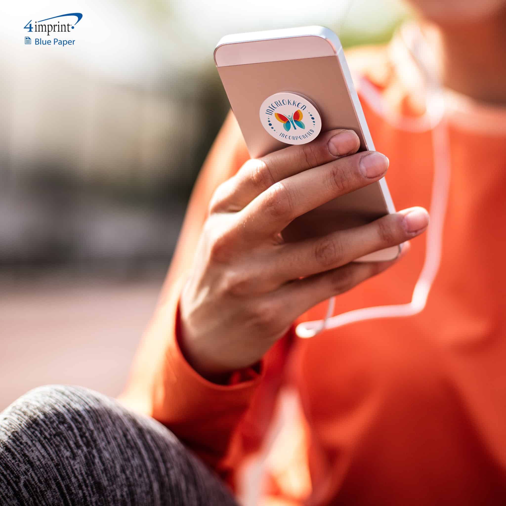Person wearing trendy heathered running pants and looking on her phone with a branded pop socket. Fashion-forward advertising promotional products get used.