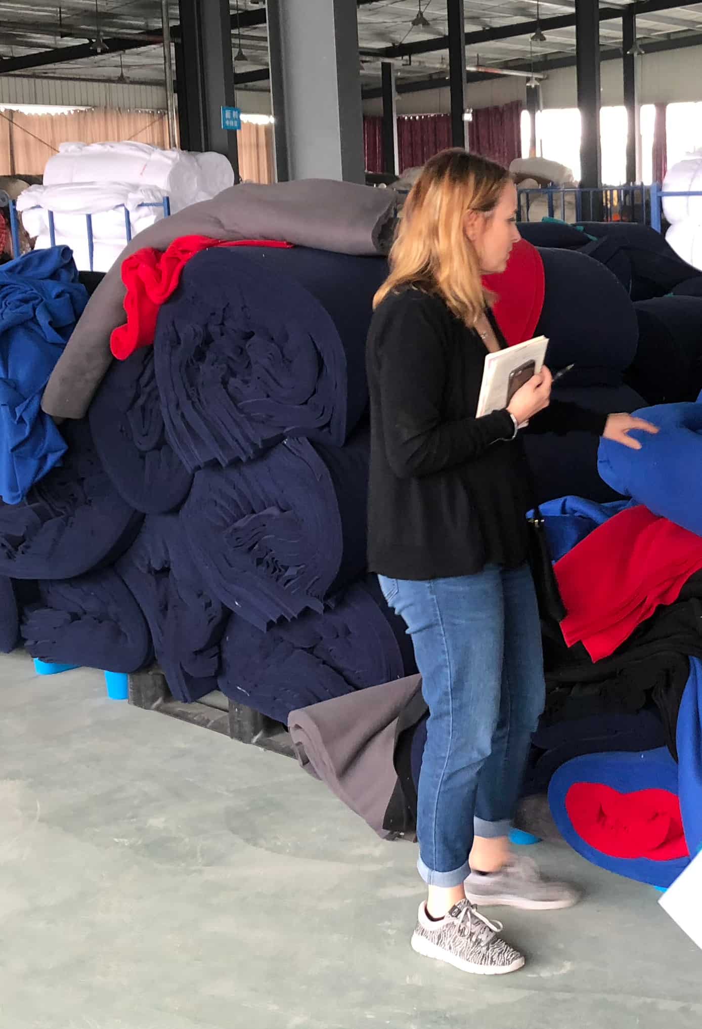 Member of 4imprint's merchandising team reviewing and selecting promo fleece fabric rolls.