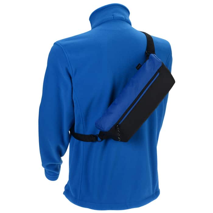 Back of blue shirt with blue and black sling pack slung over