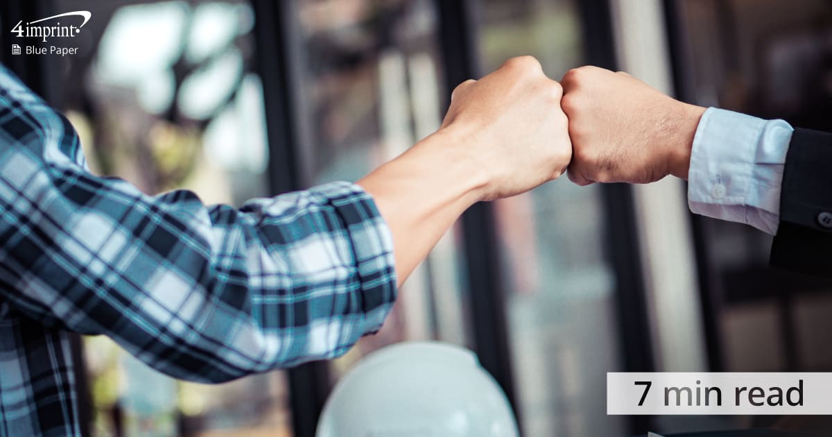 two people fist bumping - content will be a 7 min read - represents the Blue Paper called - Build big business benefits with company community service