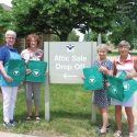 Attic Angel Volunteers holding custom reusable grocery bags purchased with a 4imprint one by one® grant.