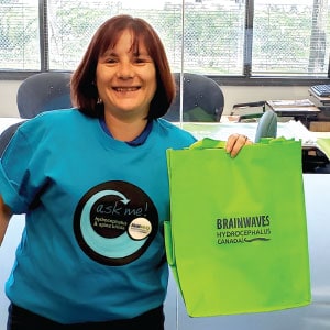Female employee of Hydrocephalus Canada with promotional bag