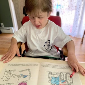 Child using a promotional coloring book from Share the Voice.