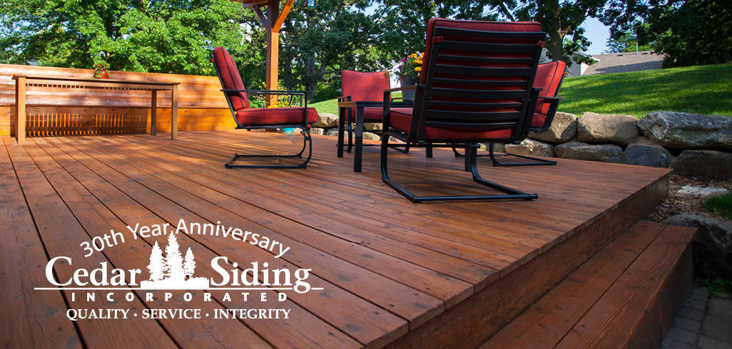 A picture of a deck with a 30th anniversary Cedar Siding Incorporated logo included.