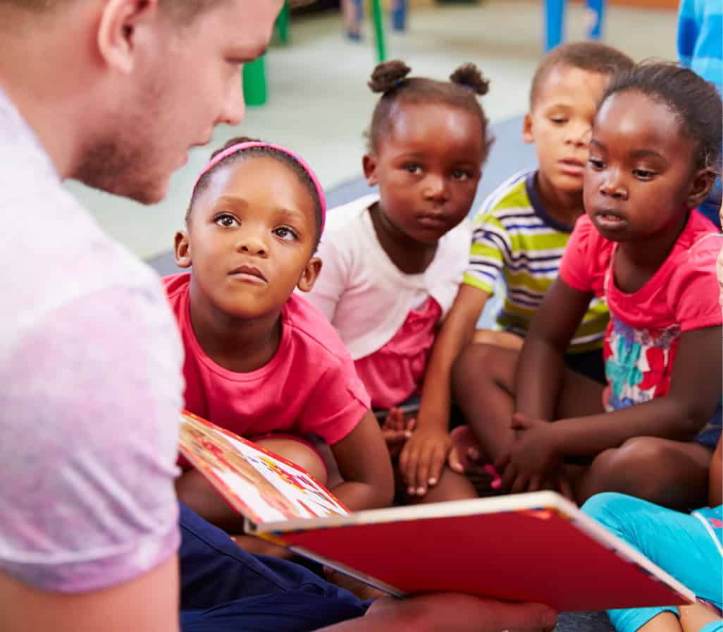 A person reading to children.