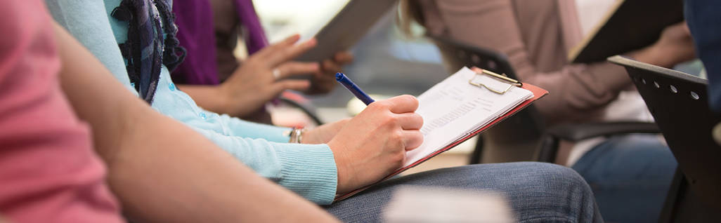 A person taking notes during a training session.