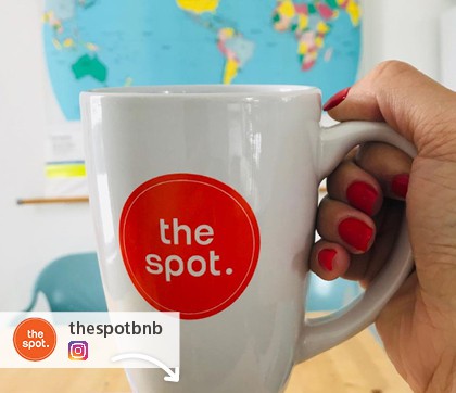 Instagram picture of a promotional mug with The Spot logo on it