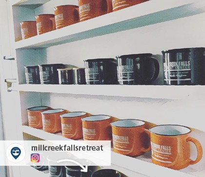 Instagram picture of shelves filled with black and orange promotional mugs