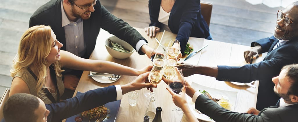 A group of people at a holiday party toasting the occasion