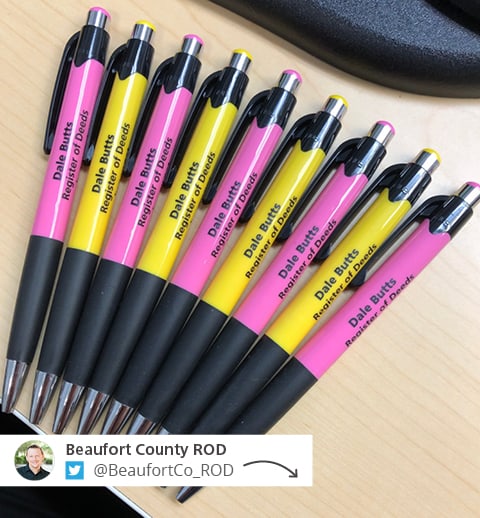 Social post showing a number of yellow and pink promo pens.