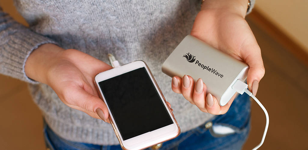 Photo of person holding branded power bank.