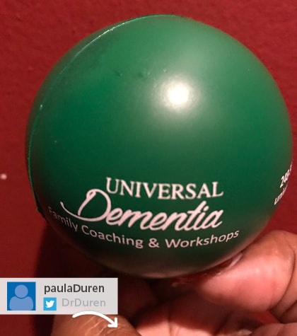A Twitter post of a green promotional stress ball with Universal Dementia logo on it
