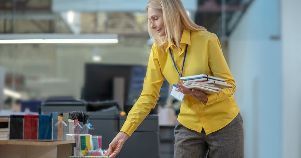 Woman collecting notepads.