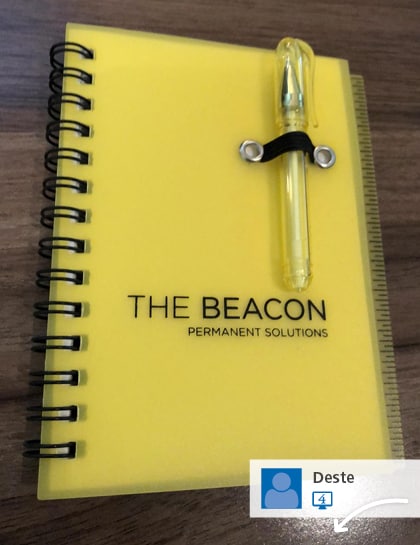 A social media post showing a branded portfolio with attached pen.