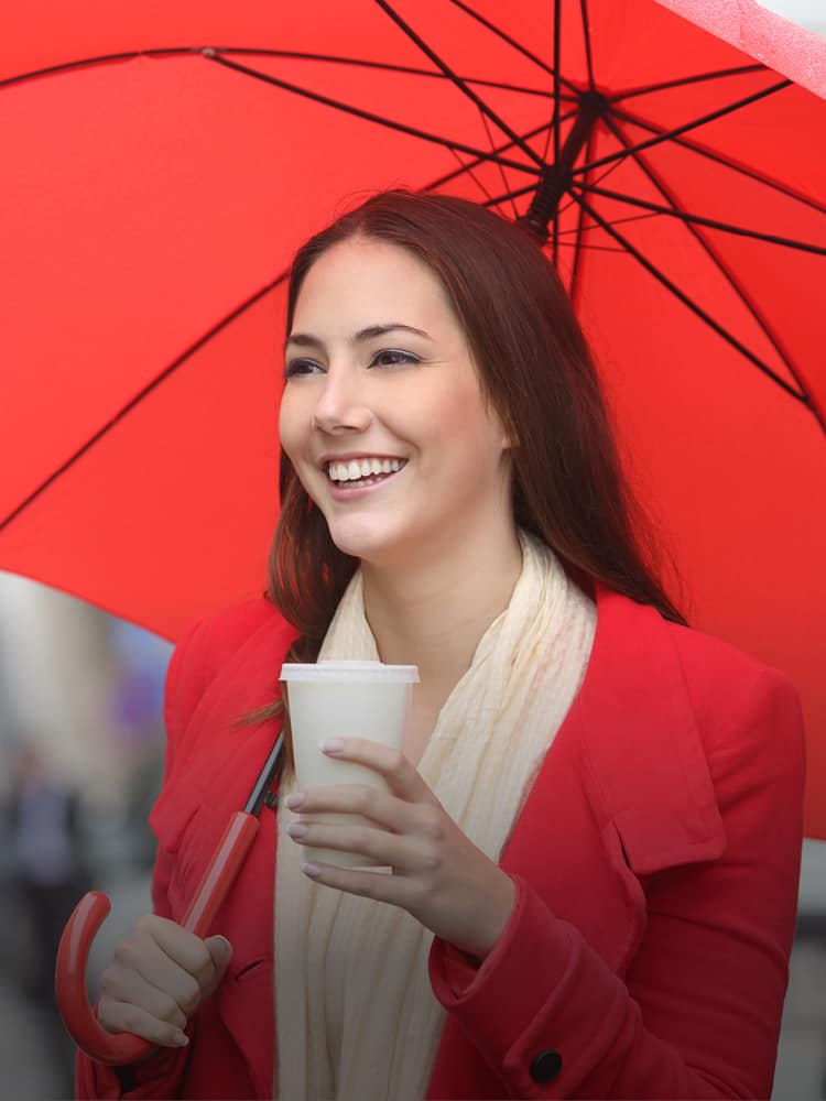 A woman holding an open umbrella