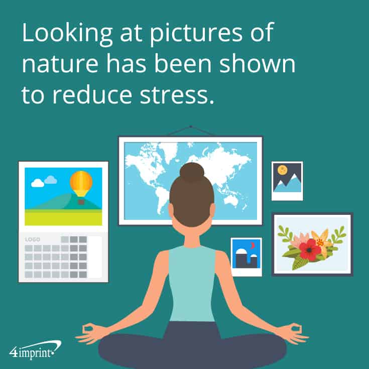 Woman in meditation pose facing beautiful pictures, a map and a calendar.