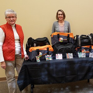 Jackson County GAL/CASA employees display the personalized sports duffel bags.