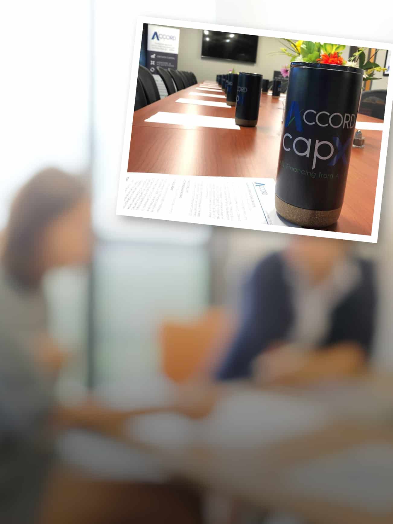 A conference room set up for a meeting with branded giveaways of logoed drink cups at each seat