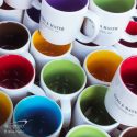 a colorful group of branded promotional mugs. The Power of Swag Colours