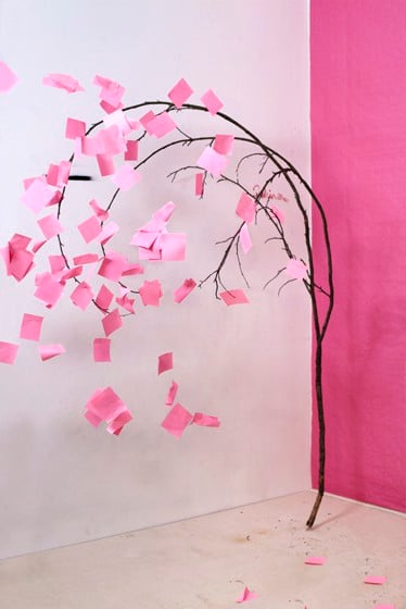 A branch with Post-It Notes attached.