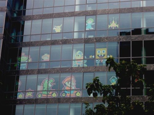 A variety of Post-it note window decorations based on pop culture.